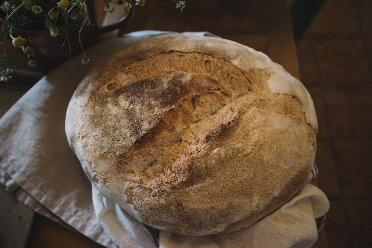 A close-up of homemade rustic sourdough bread, highlighting its texture and crust.